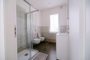 a bathroom with a toilet and a glass shower at Residenza La Boheme in Verona +29 photos