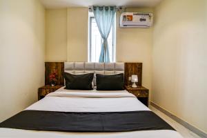 a bedroom with a large bed with a window at The Hastings Club in Kolkata