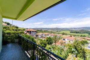 a balcony with a view of a town at Gondomar Guimarães - Moradia V3 com piscina natural by House and People in Guimarães