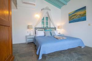 錫米的住宿－Emporio A Captivating 6-Bed Villa in Nimborio，一间卧室配有一张蓝色的床和窗户
