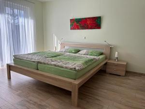 a bedroom with a large bed with a wooden frame at Ferienhaus Eschauel in Nideggen
