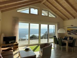 a living room with a table and a large window at Ferienhaus Eschauel in Nideggen