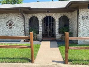 two wooden benches in front of a building at StockYards! Walk 3 Blocks-Ranch House sleeps 8 in Fort Worth