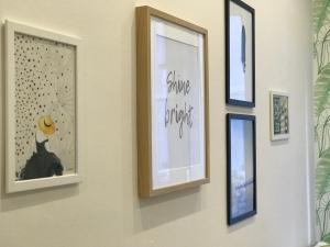 a group of framed pictures on a wall at FIKA FLAT Casco ViejoPARKING 15 x día in Bilbao