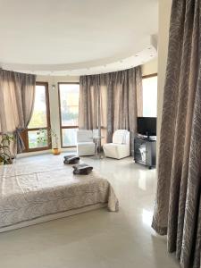 a large bedroom with a large bed and a couch at Вила Фреди in Varna City +31 photos