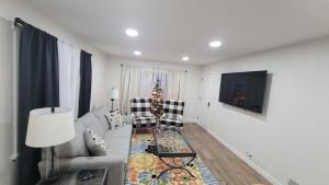 a living room with a couch and a christmas tree at Pet Friendly 5 Bed Home with Waffle Breakfast in Ogden