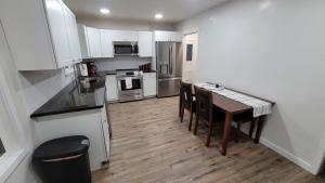 a kitchen with white cabinets and a wooden floor at Pet Friendly 5 Bed Home with Waffle Breakfast in Ogden