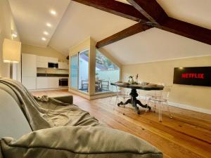 a living room with a table and a kitchen at [Villa Migliorini] Lusso & Comfort in Finalborgo. in Finale Ligure