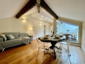 a living room with a table and a couch at [Villa Migliorini] Lusso & Comfort in Finalborgo. in Finale Ligure +31 photos