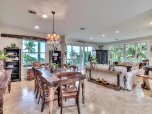 a dining room and living room with a table and chairs at Sol Mar-Oceanfront Beachhouse in Captiva