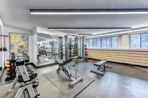 a gym with several treadmills and machines in it at House crescent in Montreal