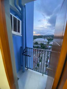 a balcony with a view of a city at Northwoods Place Studio Unit in Mandaue City