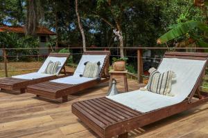 three hammocks sitting on a deck with at Casa Amadou com grande piscina em Boipeba in Ilha de Boipeba