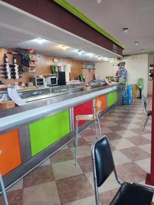 a kitchen with a counter with chairs in a restaurant at hostal restaurante galicia in Villardefrades