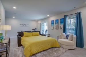 a bedroom with a yellow bed and a chair at Townhome with 2 Decks 3 Mi to Ocean City Boardwalk in Berlin