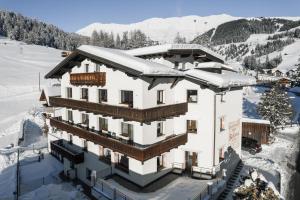 a building with snow on top of it at Haus Bellevue by VAYA in Serfaus