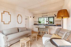 a living room with a couch and a table at Glamping Terre di Sacra in Tuscany in Capalbio