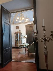 a hallway with a room with a table and a chandelier at B&B - La Corte D'Ivi in Collepardo