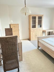a bedroom with a bed and a desk and a chair at Museum Lust auf Zuhause Ferien in der Provinz in Herford +12 photos