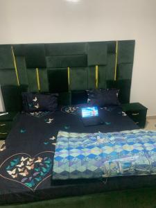 a bedroom with a bed with a laptop on it at diallo appartement1 in Ngor