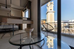 a room with a glass table and a clock tower at CLOCK Central Stay in Xanthi