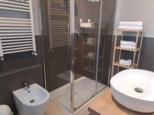 a bathroom with a shower and a toilet and a sink at Bolognamania Rooms-Saffi in Bologna
