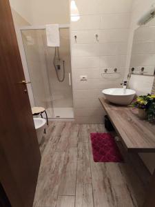 a bathroom with a sink and a toilet and a shower at Rodoflor Rooms in Castellammare di Stabia