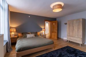 1 dormitorio con 1 cama grande y 2 mesitas de noche en Maison d'hôte Brasserie Caulier en Péruwelz