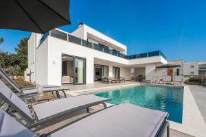 a villa with a swimming pool and a house at Villa Bella Ciao by SeeAdria Agency in Novigrad Istria