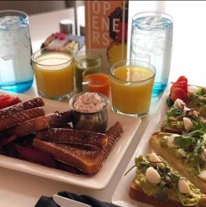a table with a plate of breakfast foods and drinks at Le Meridien Arlington in Arlington