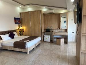 a bedroom with a large bed and a kitchen at Beyond OTEL in Antalya