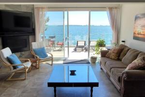 a living room with a view of the ocean at SkyTime Vacations in Wellington
