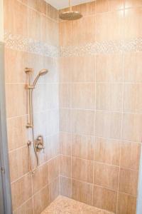 a bathroom with a shower with a tiled shower at SkyTime Vacations in Wellington