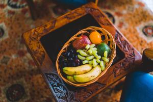 a basket of fruit sitting on a table at The Mallard by Evoke Hotels in Srinagar