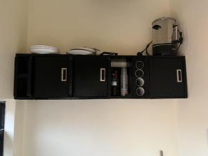 a black shelf on the wall with a appliance at Beautiful 1-Bed Apartment in Gulu in Gulu