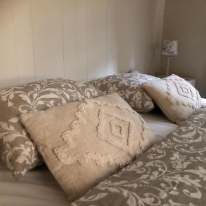 a bed with two pillows on top of it at Chalet Relax in Zutendaal