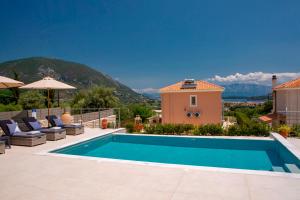 a villa with a swimming pool with mountains in the background at Villa Marianna II in Nydri