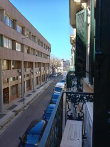 a row of cars parked on a balcony of a building at Piazza Verdi Liberty House in Lecce