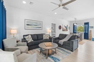 a living room with two couches and a table at Blue Pearl New Waterfront Haven with Heated Pool ,70 Foot Dock, and More! in Marathon +62 photos