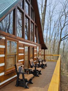 a group of benches sitting on the deck of a cabin at Meadows Way 3378 in Pigeon Forge