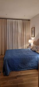 een slaapkamer met een bed met een blauw dekbed bij CasaDeVita in Tazacorte