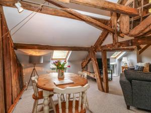 a living room with a wooden table and chairs at Millers Loft in Llanrwst