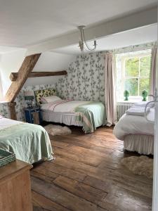 a bedroom with two beds and a window at The Pink House in Brecon