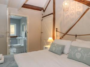 a bedroom with a bed and a bathroom at Millers Loft in Llanrwst
