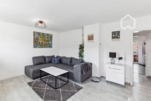 a living room with a couch and a table at Apartment close to VF Tower - 53 SQM - Fair - Kitchen in Düsseldorf