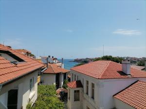 a view of roofs of houses and the water at Guesthouse Olimp in Sozopol