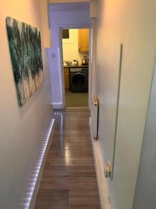 a hallway leading to a kitchen with a hallway at The Chelsea - 2 Bed Haven in London