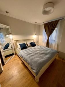 a bedroom with a large bed with blue pillows at Kalim’s apartment in Arad