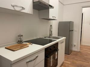 a kitchen with a sink and a refrigerator at 'La Perla' nel centro di Frascati in Frascati