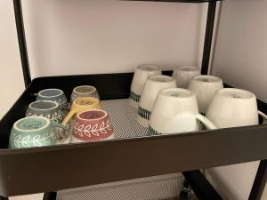 a drawer filled with different colored jars and vases at 'La Perla' nel centro di Frascati in Frascati +10 photos